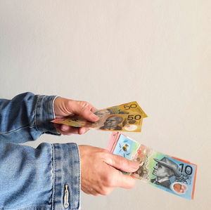 Cropped female hands holding australian currency