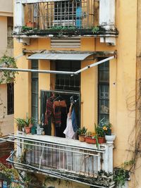 Rear view of woman standing in front of building