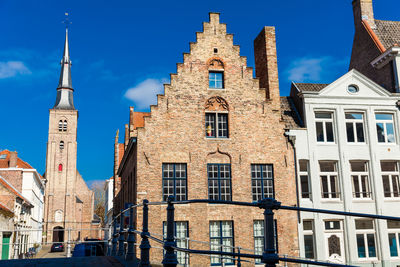 Low angle view of buildings against blue sky