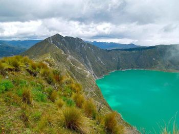 Scenic view of mountains against cloudy sky