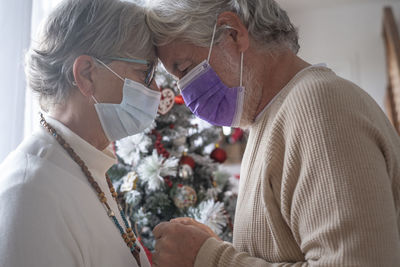 Portrait of people holding christmas tree