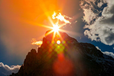 Sunlight streaming through clouds during sunset