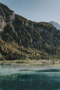 Scenic view of lake by mountains against sky