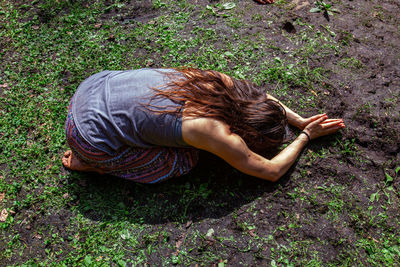 High angle view of woman lying on land