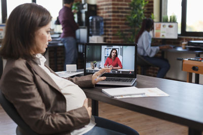 Pregnant woman talking on video call