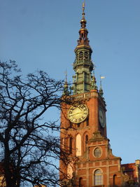 Low angle view of clock tower against sky