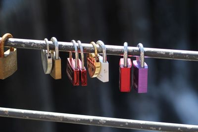 Close-up of padlocks hanging on railing