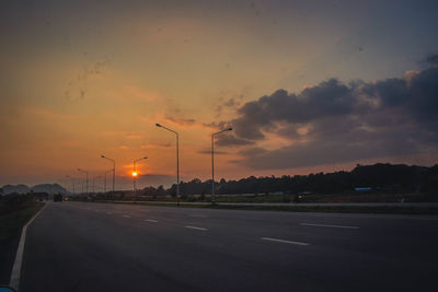 Street against sky during sunset