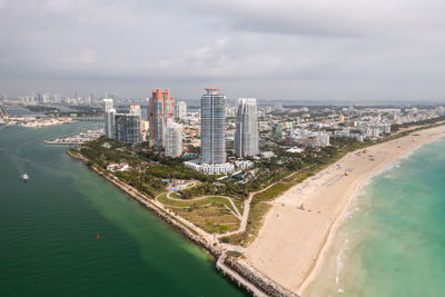 High angle view of sea and buildings against sky