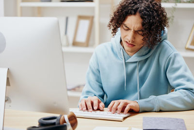 Businesswoman working on desktop computer at table