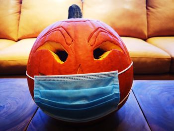 Close-up of pumpkin on sofa