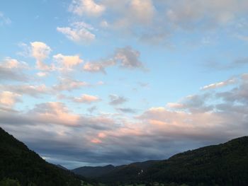 Scenic view of mountains against cloudy sky