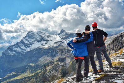 Man standing on snowcapped mountains against sky