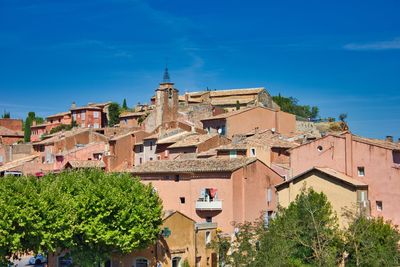 Low angle view of buildings against blue sky in beaux de provence