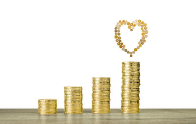 Stack of coins on floor against white background