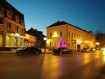 Cars in illuminated city at night