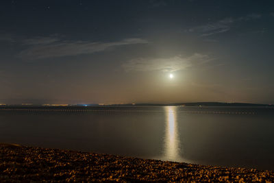 Scenic view of the full moon over rijeka over the sea against clear sky at night