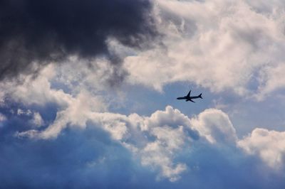 Low angle view of airplane flying in sky