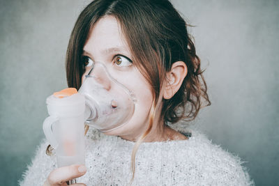 Portrait of a young woman drinking water