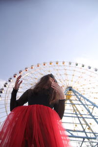 Rear view of woman with umbrella against clear sky
