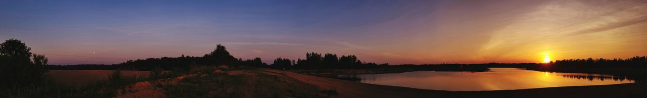 Panoramic view of silhouette trees against sky during sunset