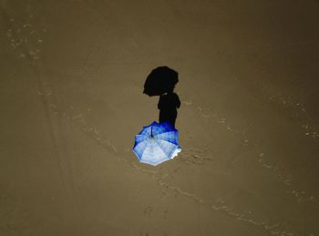 Rear view of woman walking on beach