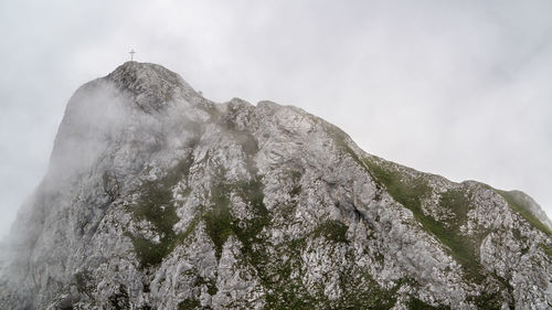 Low angle view of snowcapped mountain against sky