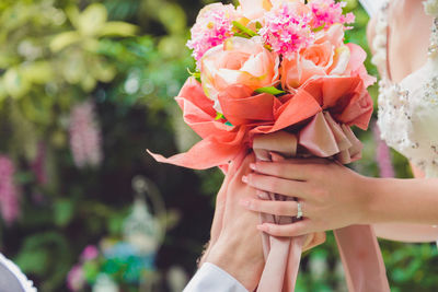 Bouquet in the hands of the groom. to make a happy wedding gift to a young bride.