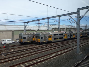 Train on railroad tracks against sky. this is sydney train service of australia.