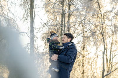 Happy father carrying son in park