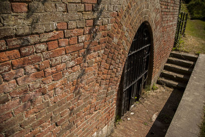 Footpath by brick wall