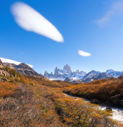 Scenic view of mountains against blue sky