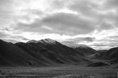 Scenic view of mountains against cloudy sky