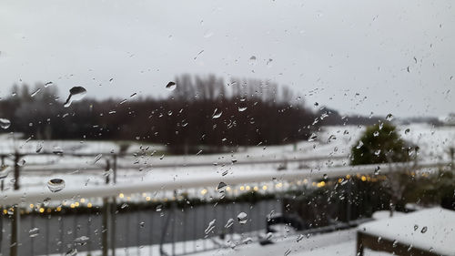 Raindrops on glass window of rainy season
