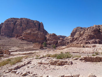 View of rocky mountains against clear blue sky