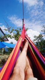 Low section of person relaxing on hammock