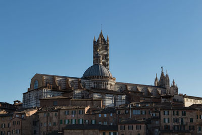 Low angle view of buildings against blue sky