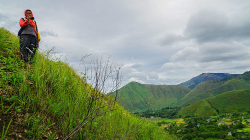 Scenic view of green landscape against sky