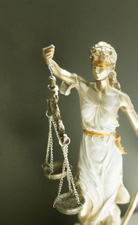 Lady justice against gray wall