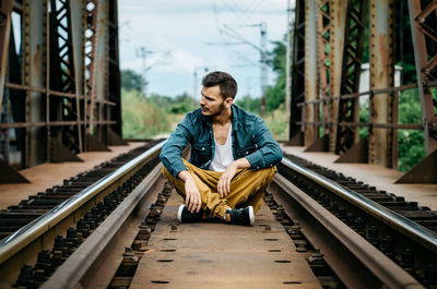 Man standing on railroad track