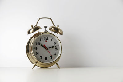 Close-up of alarm clock against white background