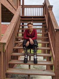 Portrait of young woman sitting on staircase