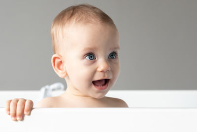 Portrait of cute baby boy sitting on table