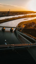 High angle view of bridge over river against sky during sunset