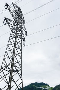 Low angle view of electricity pylon against sky