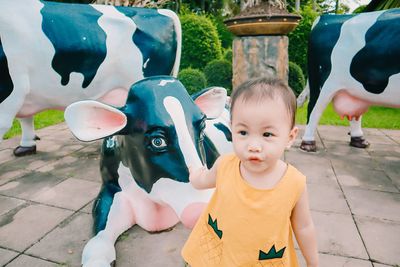 Portrait of cute girl with toy on footpath