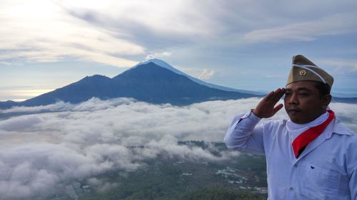 Man standing on mountain against sky