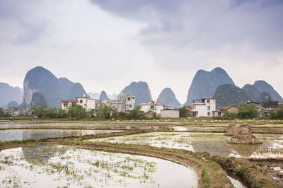 View of buildings against cloudy sky