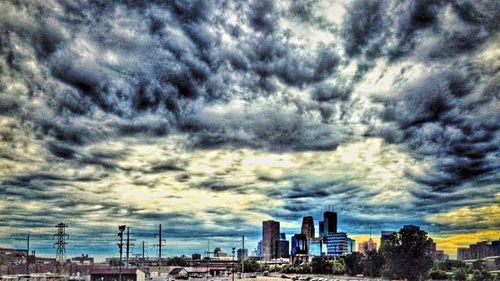 Cityscape against cloudy sky