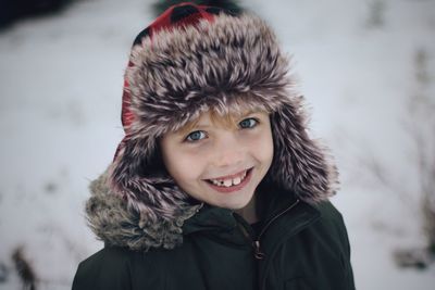 Portrait of smiling boy in snow